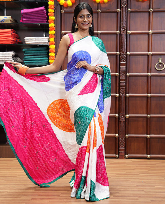 White base multi-color bandhani dots enclosed circle printed with mirror work moss chiffon saree, contrast piping border, pallu of print, stone work and mirror work
