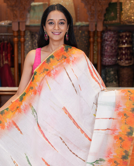 White-Orange Linen Cotton Saree Features Watercolor Painting-style Shibori Print, Contrast Printed Border, Printed Pallu, and a Contrast Blouse