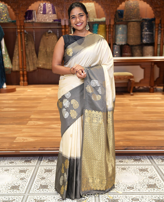 Cream Elite Soft Silk Saree, Accentuated with Zari Buttas All Over Its Body, Complemented by Contrast Border Steeped with Zari Buttas, Grand Jaal Design Pallu, and Paired with a Contrast Blouse