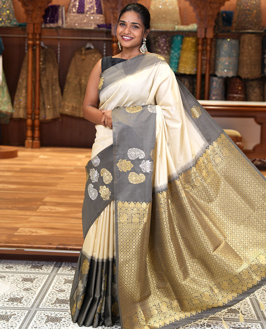 Cream Elite Soft Silk Saree, Accentuated with Zari Buttas All Over Its Body, Complemented by Contrast Border Steeped with Zari Buttas, Grand Jaal Design Pallu, and Paired with a Contrast Blouse