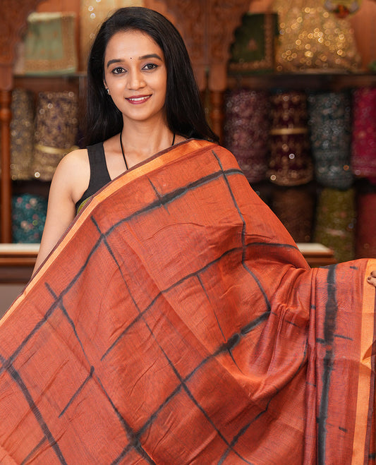Rust Linen Cotton Saree, Adorned with Shibori Checks, a Subtle Piping Border, Geometric Pallu, and a Matching Blouse