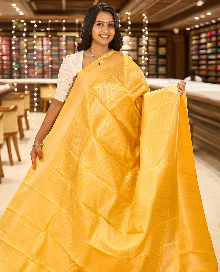 Yellow-color base rose-gold jacquard Kanchipuram silk saree, zari border & diamond buttas woven pallu