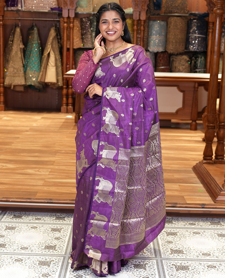 Violet Art Tussar Saree, Delicately Woven with Gold Zari Buttas All Over Its Body, Highlighted by a Zari Border of Pichwai Cow Motifs, Grandly Woven Pallu, and Paired with a Matching Blouse