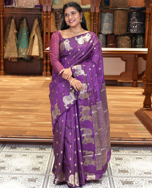 Violet Art Tussar Saree, Delicately Woven with Gold Zari Buttas All Over Its Body, Highlighted by a Zari Border of Pichwai Cow Motifs, Grandly Woven Pallu, and Paired with a Matching Blouse