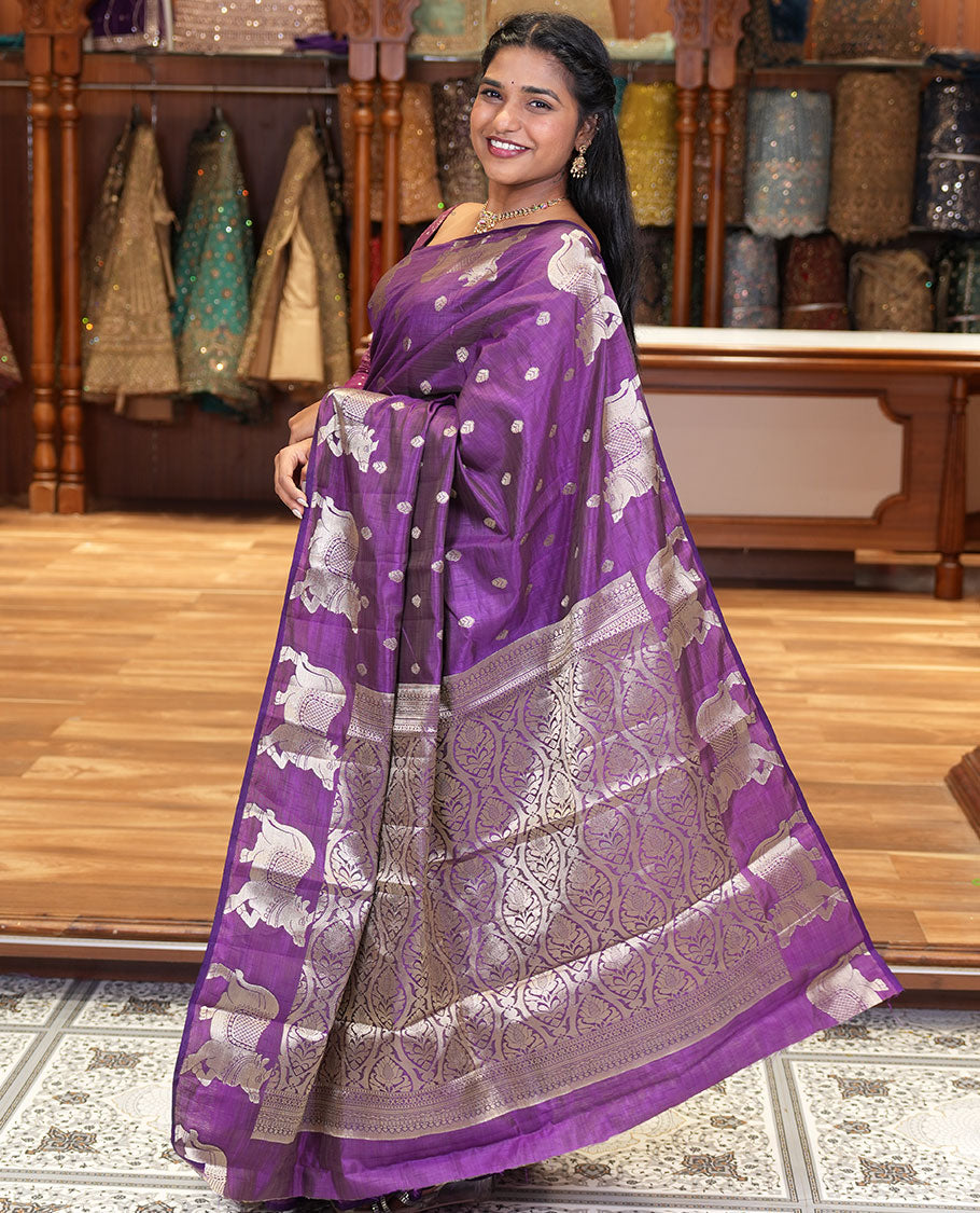 Violet Art Tussar Saree, Delicately Woven with Gold Zari Buttas All Over Its Body, Highlighted by a Zari Border of Pichwai Cow Motifs, Grandly Woven Pallu, and Paired with a Matching Blouse