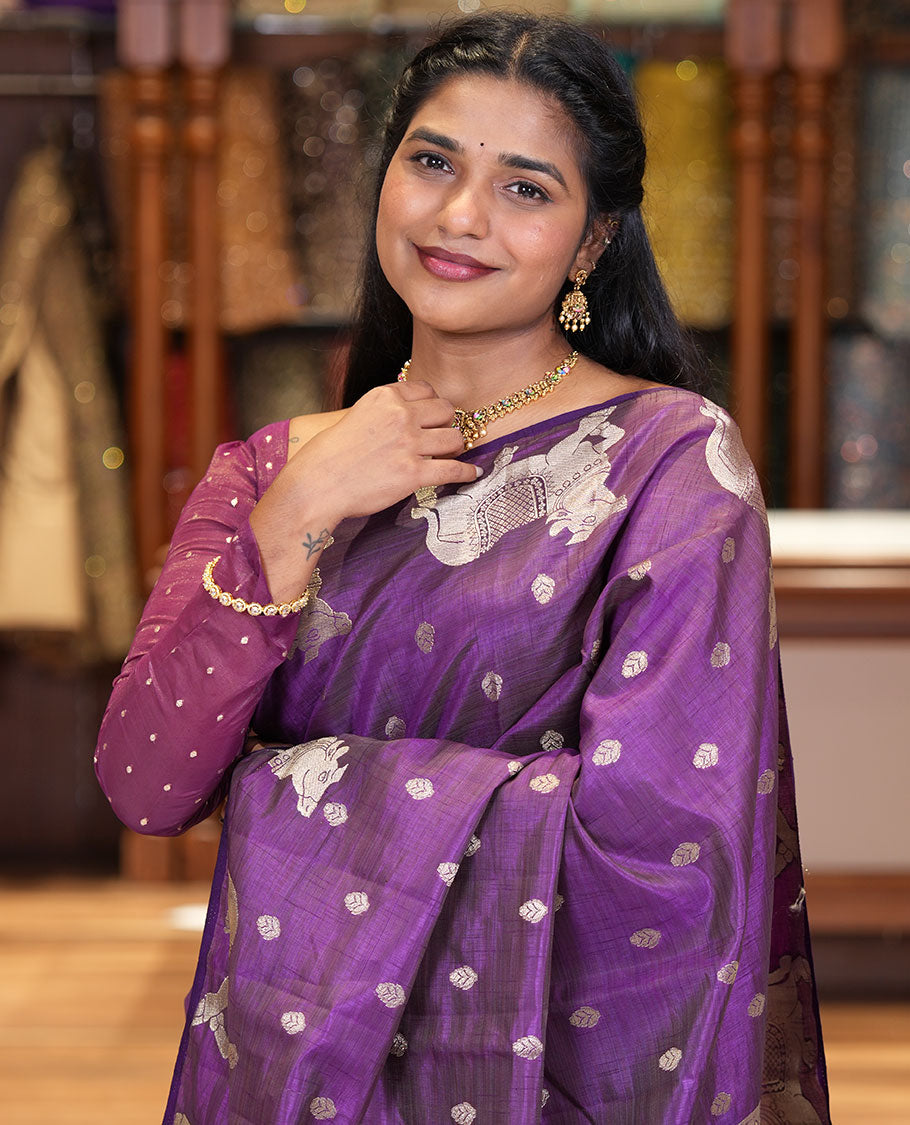 Violet Art Tussar Saree, Delicately Woven with Gold Zari Buttas All Over Its Body, Highlighted by a Zari Border of Pichwai Cow Motifs, Grandly Woven Pallu, and Paired with a Matching Blouse