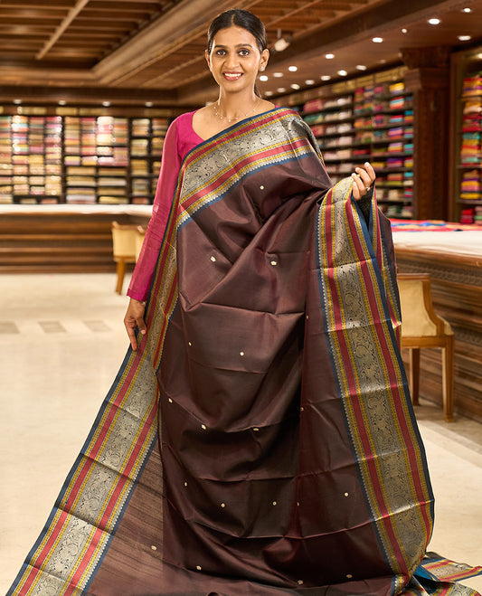 Brown mayil chakram thread buttas Kanchipuram silk saree, contrast border of thilakam mokku, mayil, yaali, and rudraksham, and pallu of big Nava Nari Kunjara motif