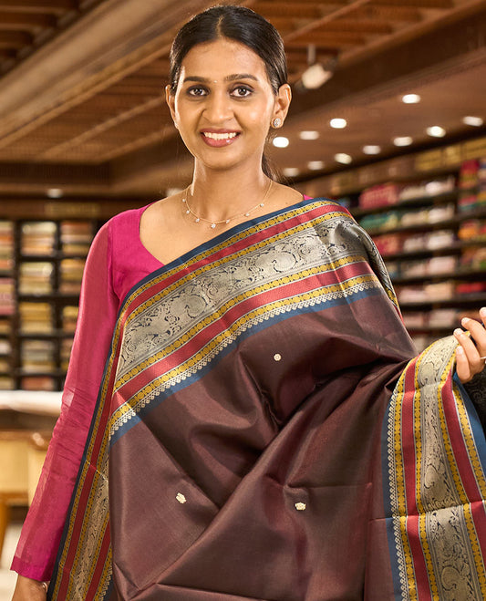 Brown mayil chakram thread buttas Kanchipuram silk saree, contrast border of thilakam mokku, mayil, yaali, and rudraksham, and pallu of big Nava Nari Kunjara motif