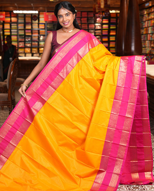Yellow-Pink Budget Silk Saree, Accentuated with Zari Stripes, Contrast Rettai Pettu Peacock Border, Grand Pallu, and a Contrast Blouse