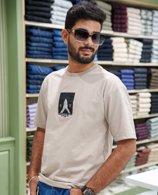 Cream Cotton-Blended T-shirt, Features Unique Back Print, Half-sleeves, Crew Neck, Oversized Fit, and Regular Length 