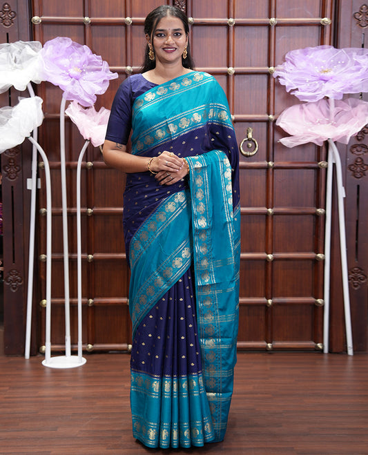 Navy Blue Art Mysore Silk Saree, Elevated with Zari Buttas All Over Its Body, Complemented by a Contrast Rettai Pettu Border of Two-Headed Eagle Designs, Pallu Steeped with Buttas and Stripes, and Paired with a Contrast Blouse