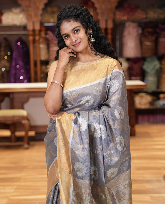 Grey floral jaal jacquard tissue silk saree, contrast bavanji border, floral design pallu, and a scallop design blouse