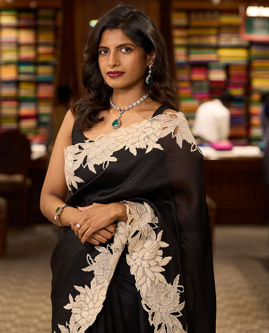 Black organza saree with contrast floral embroidery, cut work border