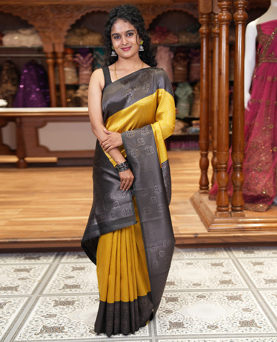 Yellow zari buttas and checked kanchi silk saree, contrast border of zari buttas, and checks, intricate pallu, and contrast zari bordered blouse