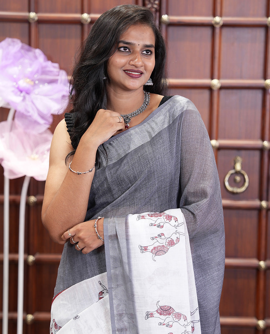 Cream and Grey Linen Cotton Saree, Subtly Sparkled with Half-and-Half Style and Elephant Motifs Printed On Its Body, Highlighted by Zari Border, Pallu of Same Print, and Paired with a Printed Blouse