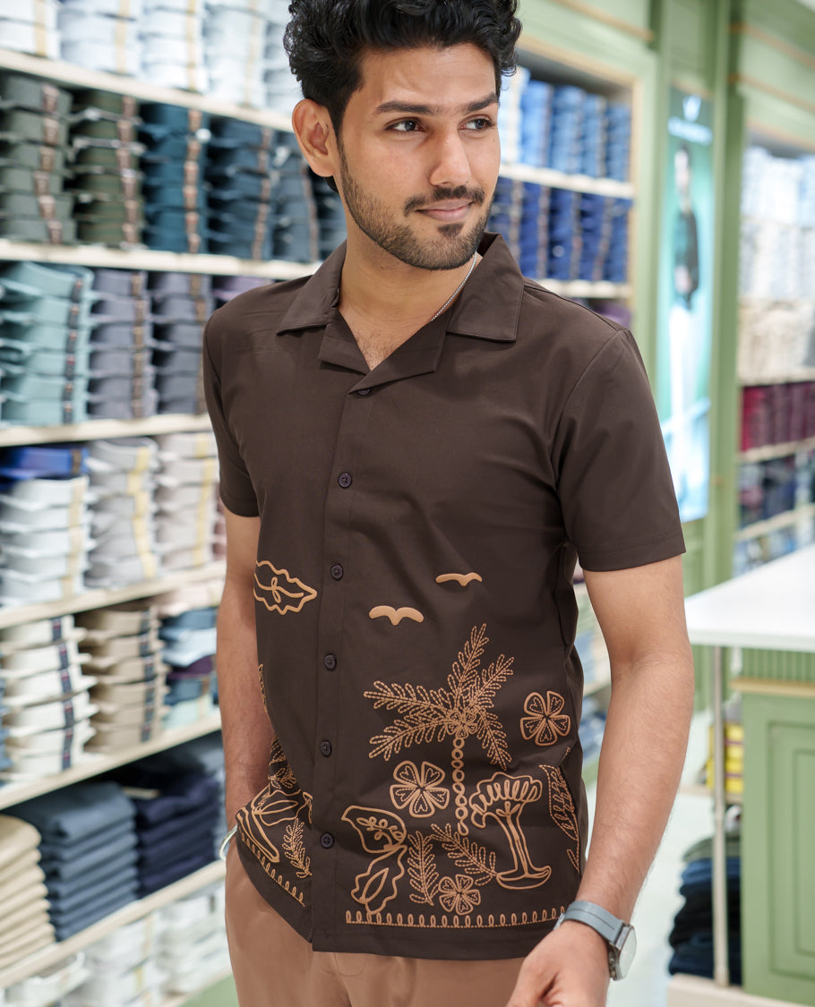 Brown Cotton-Blended Casual Shirt Comes with a Tropical Floral Embroidery, a Cuban Collar Neck, Half Sleeves, a Regular Fit, and Regular Length