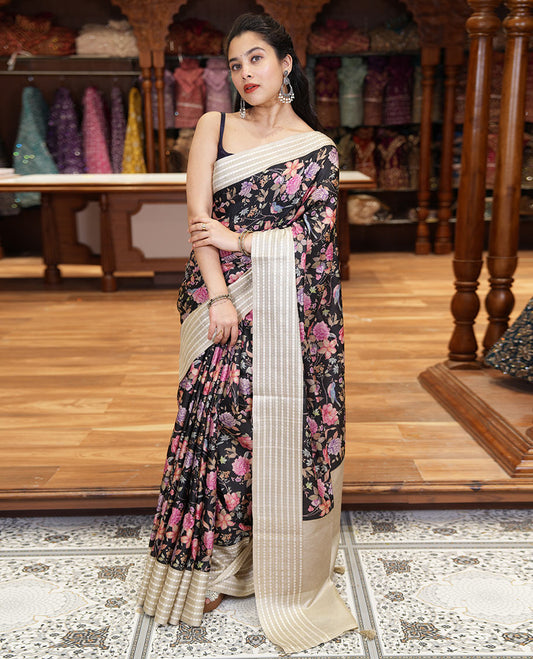 Black colorful floral motifs printed fancy tussar saree, contrast triangle motifs border, striped pallu, and a contrast striped blouse