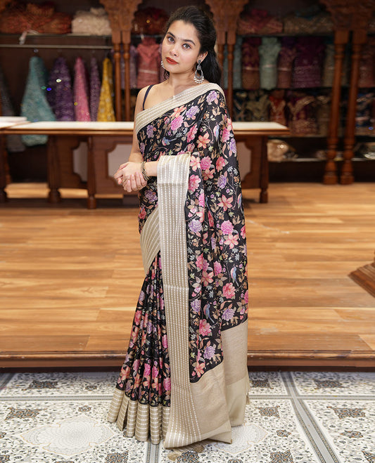 Black colorful floral motifs printed fancy tussar saree, contrast triangle motifs border, striped pallu, and a contrast striped blouse