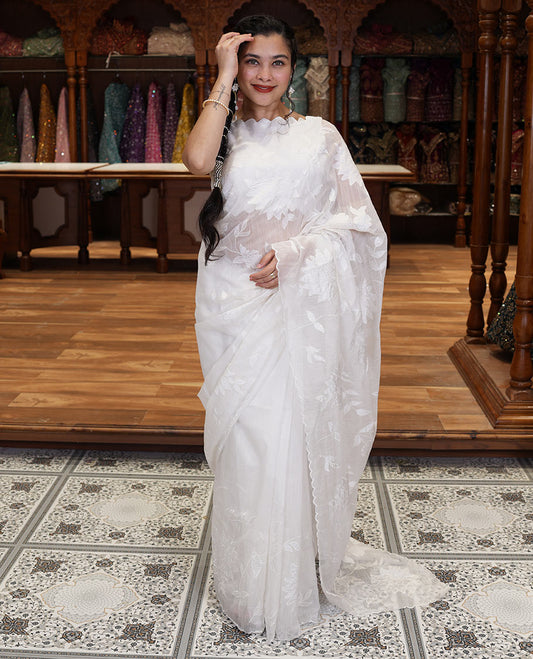 White floral vine applique embroidered linen saree, scallop border, floral motifs embroidered pallu, and a plain blouse