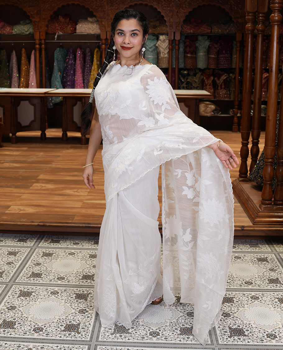 White floral vine applique embroidered linen saree, scallop border, floral motifs embroidered pallu, and a plain blouse