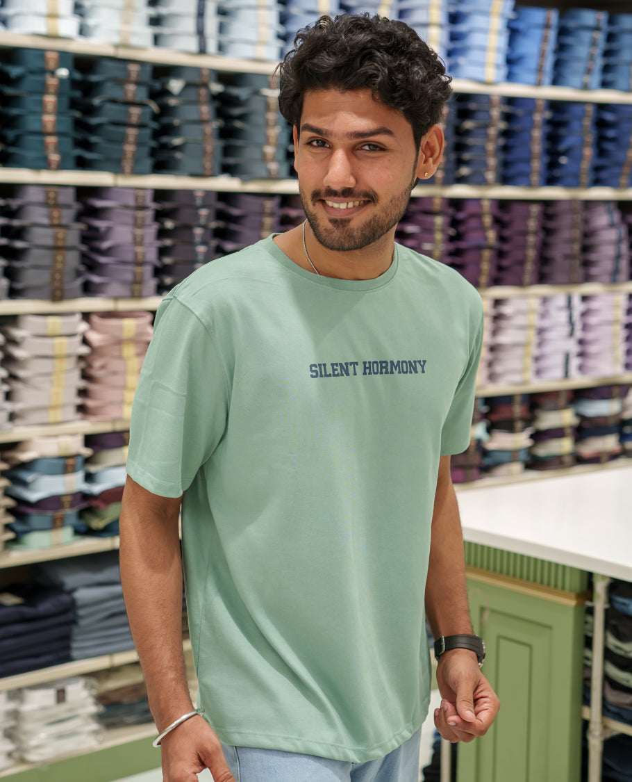 Green Cotton-Blended T-Shirt Comes with an Tree-Motifs Back Print, Crew Neck, Half Sleeves, Oversized Fit, and Regular Length