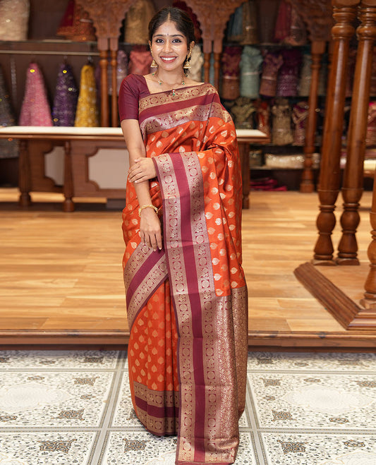Rust orange zari buttas kanchi silk saree, contrast traditional rettai pettu border of peacock chakram, intricate pallu, and a zari design pallu