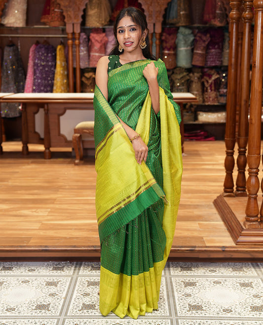 Peacock green zari dot enclosed checked semi-raw silk saree, contrast traditional zari design border, contrast diamond patterned pallu, and a contrast blouse