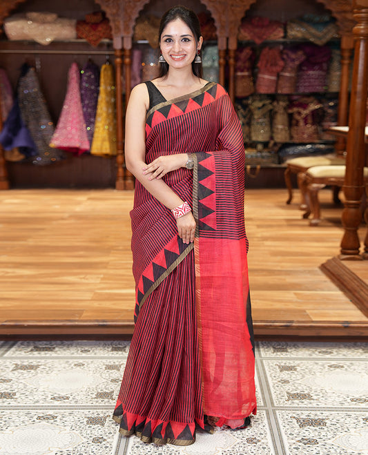 Red vertical stripes printed linen cotton saree, a temple-printed border, big polka dot printed pallu, and a printed blouse