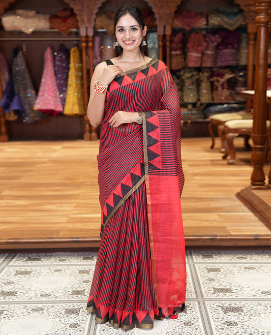 Red vertical stripes printed linen cotton saree, a temple-printed border, big polka dot printed pallu, and a printed blouse