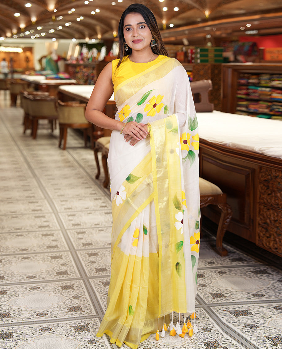 Cream and Yellow Khadi Mul Cotton Saree, Adorned with Hand-Brush Painting-Style Floral Block Printed Body, a Subtle Gold Zari Border, a Self-Pallu, and Paired with a Matching Blouse