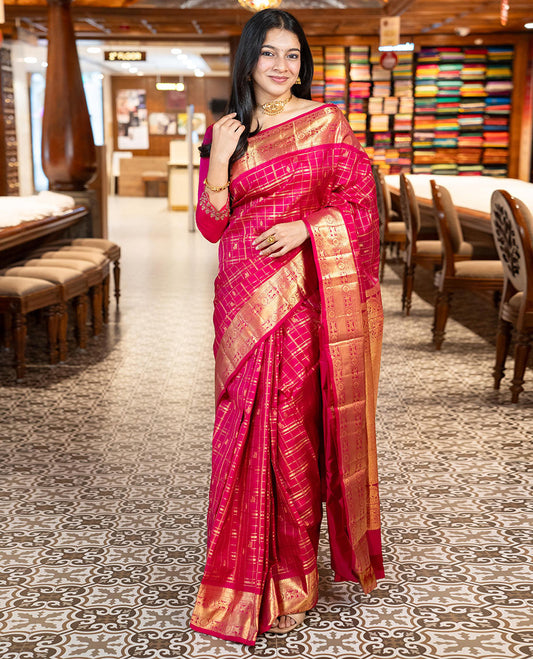 Pink Vasundhara Silk Saree Gracefully Embellished with Zari Butta Enclosed Checks, Complemented with a Zari Border of Kuthirai and Chakram Designs, Pallu of Intricate Zari-Weave, and Paired with a Matching Blouse
