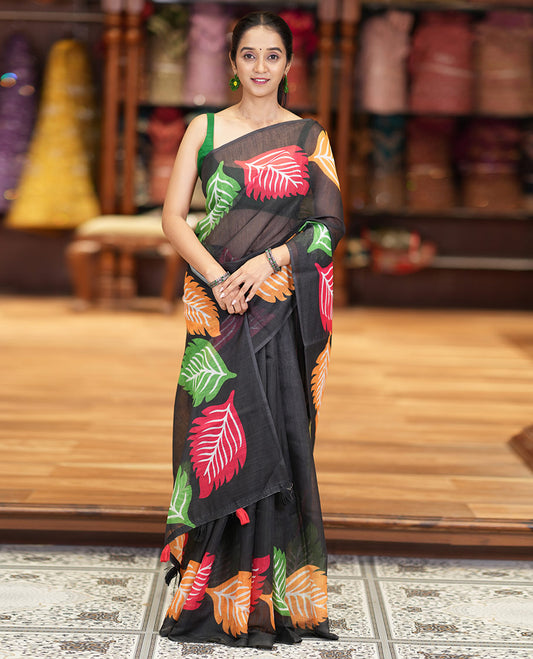 Black Plain Linen Cotton Saree Complemented by a Multi-Colored Leaf Motif Printed Border, a Pallu Mirroring the Same Print, and Paired with a Matching Striped Printed Blouse