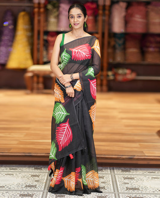 Black Plain Linen Cotton Saree Complemented by a Multi-Colored Leaf Motif Printed Border, a Pallu Mirroring the Same Print, and Paired with a Matching Striped Printed Blouse