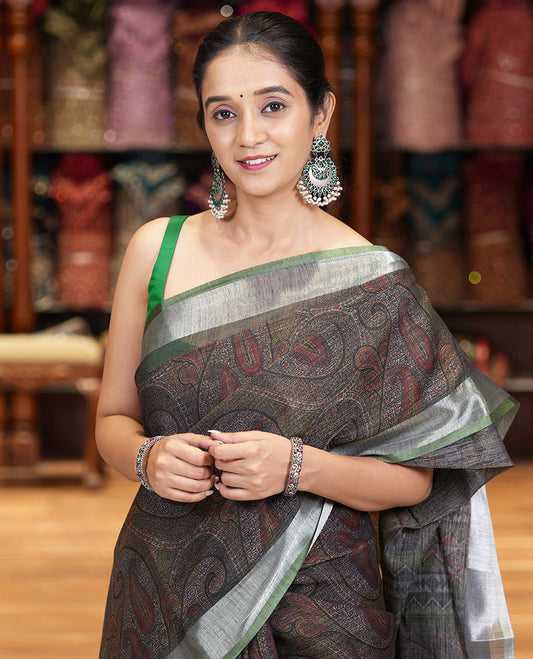 Black Printed Linen Cotton Saree Embellished with Paisley Motifs, Complemented by a Contrast Bavanji Border, Featuring Paisley Printed Pallu, Paired with a Subtle Matching Blouse