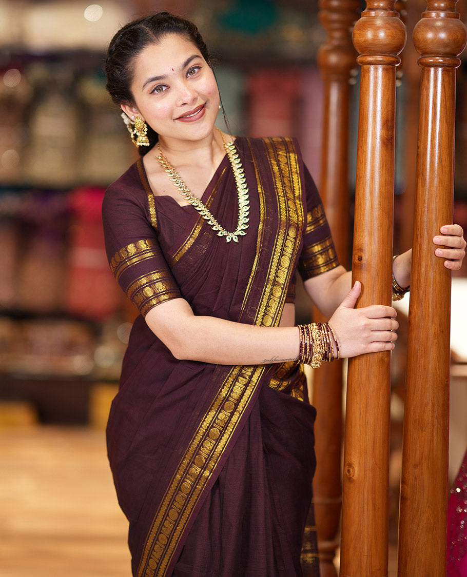 Coffee Brown Plain Chettinad Cotton Saree Graced with a Gleaming Zari Rettai Pettu Border Featuring Peacock, Rudraksham, and Neli Designs, Subtly Striped Pallu, and Paired with a Matching Blouse