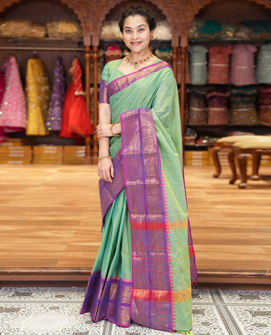 Pista Green Plain Chettinad Cotton Saree Decked Up with a Contrasting Temple Rettai Pettu Border of Peacock-Elephant Motifs, a Subtle Pallu of Stripes, and a Matching Blouse