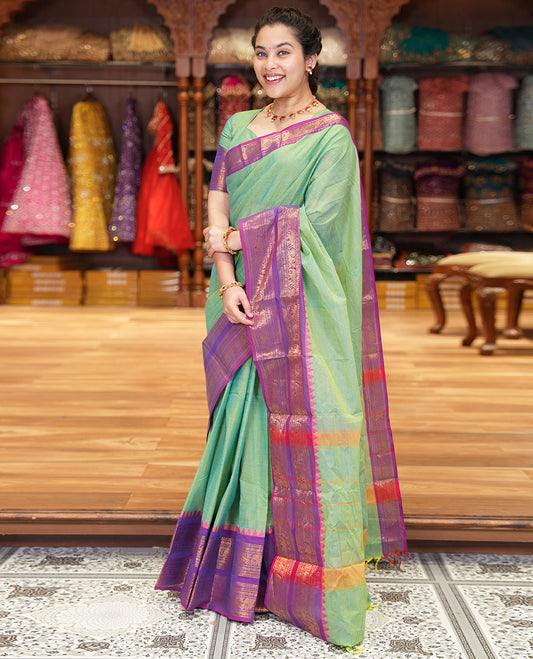 Pista Green Plain Chettinad Cotton Saree Decked Up with a Contrasting Temple Rettai Pettu Border of Peacock-Elephant Motifs, a Subtle Pallu of Stripes, and a Matching Blouse