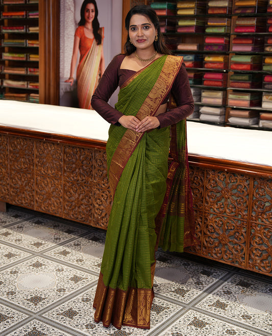 Olive Green Chettinad Cotton Saree, Gleamed Up Checked Design All Over Its Body, Complemented by a Contrast Traditional Zari Border of Peacock Designs, Zari-Striped Pallu, and Has No Blouse