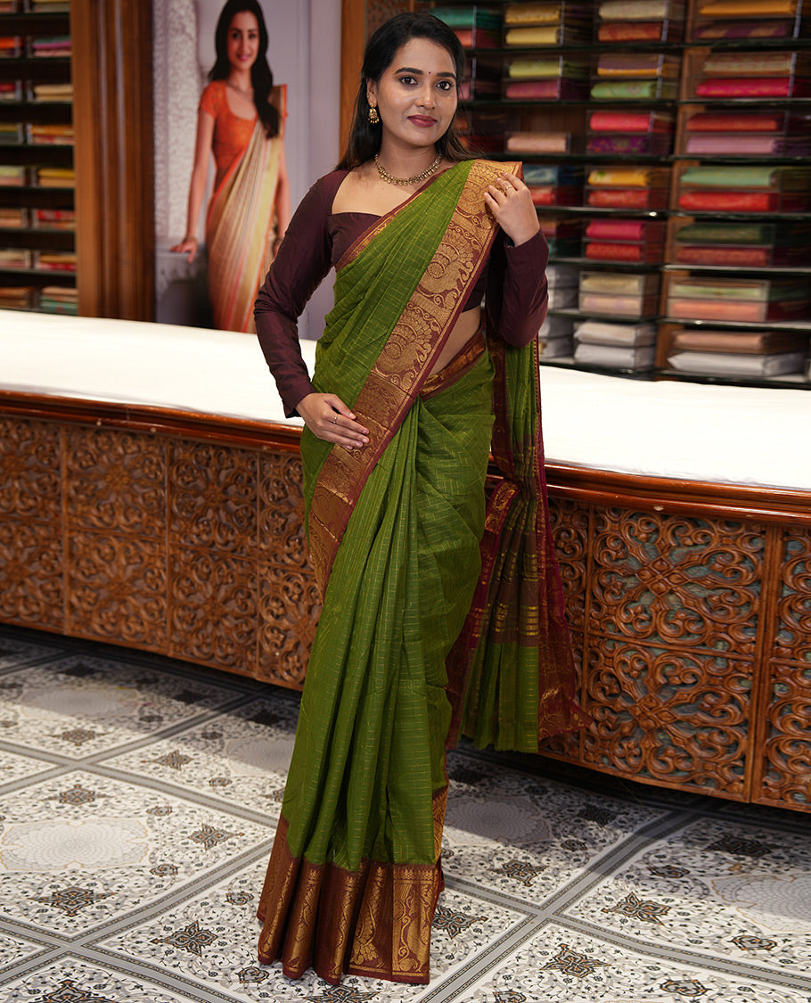 Olive Green Chettinad Cotton Saree, Gleamed Up Checked Design All Over Its Body, Complemented by a Contrast Traditional Zari Border of Peacock Designs, Zari-Striped Pallu, and Has No Blouse