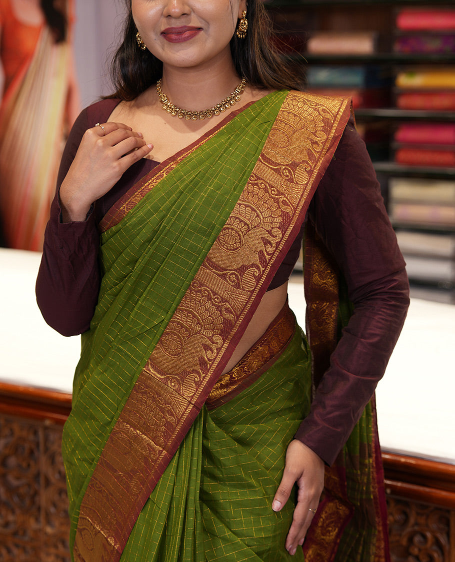 Olive Green Chettinad Cotton Saree, Gleamed Up Checked Design All Over Its Body, Complemented by a Contrast Traditional Zari Border of Peacock Designs, Zari-Striped Pallu, and Has No Blouse