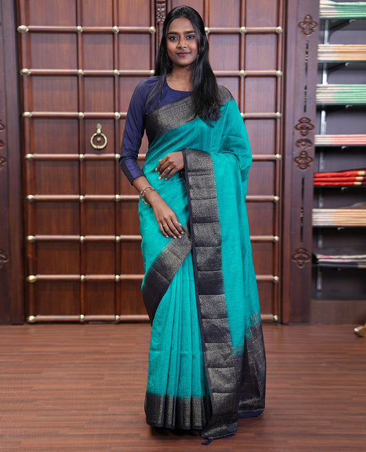 Blue Plain Jute Linen Saree, Complemented by a Contrast Hazily Woven Border of Traditional Designs, Subtly Striped Pallu, and Paired with a Contrast Blouse