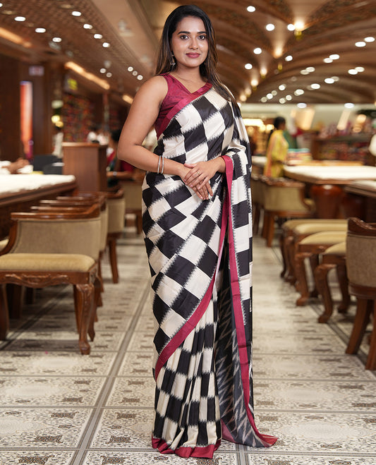 Cream and Black Satin Crepe Saree, Highlighted with Chess-Style Checked Design in Ikkat Weave, Complemented by a Contrast Border, Ikkat Chevron Printed Pallu, and Paired with a Contrast Blouse