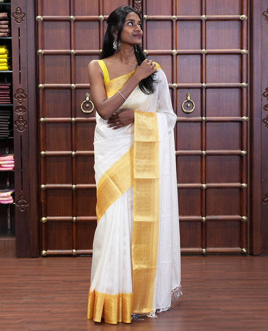 White and Yellow  Dola Silk Saree Decked Up with Vertical Zari Stripes All Over the Body, Complemented by a Contrast Border of Traditional Zari Designs, Self-Pallu of Stripes, and Paired with a Contrast Blouse
