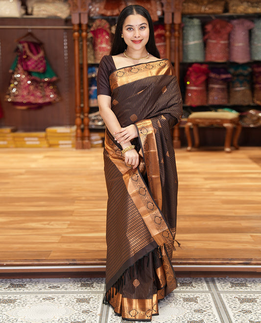Coffee Brown Kanchipuram Budget Silk Saree Prettified with Zari Stripes and Zari Buttas, Highlighted by Zari Border of Traditional Designs, Pallu Richly Detailed with Jaal Designs, and Paired with a Matching Blouse