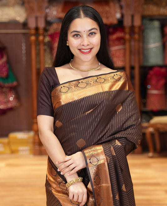Coffee Brown Kanchipuram Budget Silk Saree Prettified with Zari Stripes and Zari Buttas, Highlighted by Zari Border of Traditional Designs, Pallu Richly Detailed with Jaal Designs, and Paired with a Matching Blouse