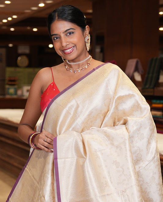 Off-White-Purple Semi-Silk Saree, Adorned with Floral Jacquard Design, a Zari Paisley Border, and a Contrast Blouse