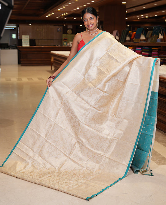 Off-White-Blue Semi-Silk Saree, Adorned with Floral Jacquard Design, a Zari Paisley Border, and a Contrast Blouse