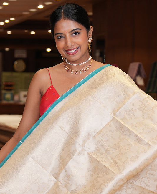 Off-White-Blue Semi-Silk Saree, Adorned with Floral Jacquard Design, a Zari Paisley Border, and a Contrast Blouse
