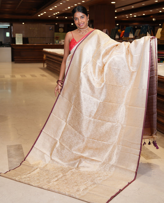 Off-White-Brown Semi-Silk Saree, Adorned with Floral Jacquard Design, a Zari Paisley Border, and a Contrast Blouse