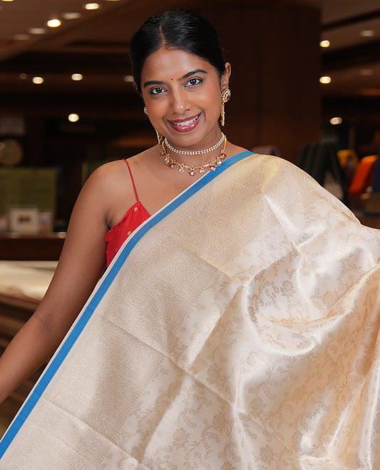 Off-White-Peacock Blue Semi-Silk Saree, Adorned with Floral Jacquard Design, a Zari Paisley Border, and a Contrast Blouse